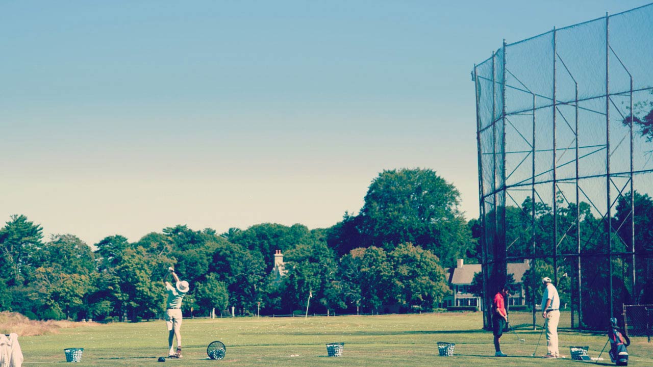 Men at golf driving range